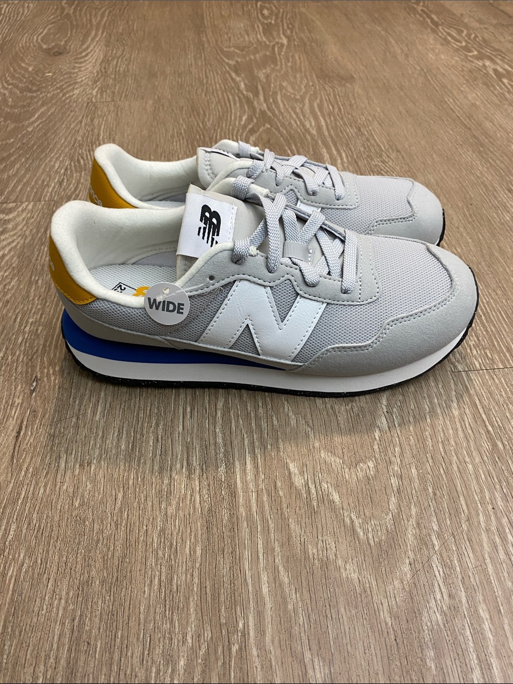 New Balance Gray Sneakers with Blue & Yellow Accents